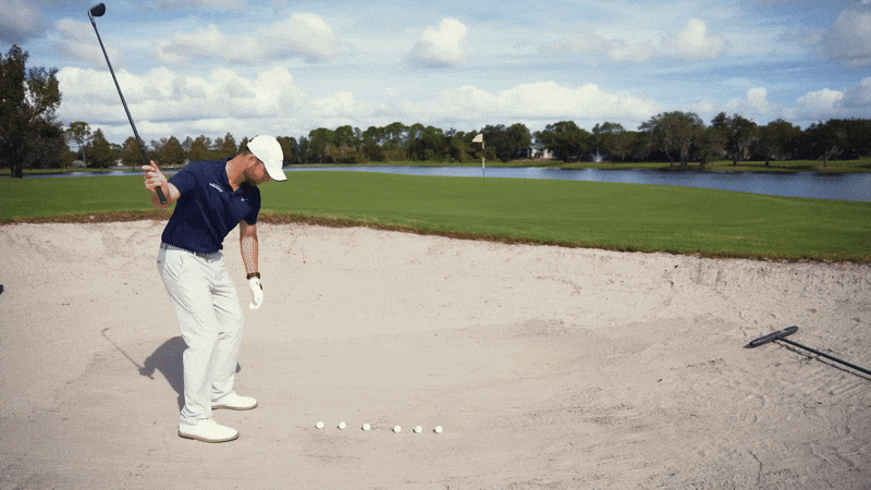 Clay hitting 5 balls one-handed from bunker